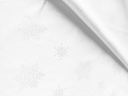 Wyjątkowa dwustronna tkanina obrusowa z brokatowym srebrnym połyskiem i plamoodporną powłoką.